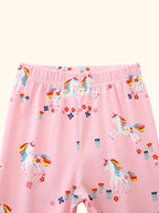 Blush pink kids unicorn print pants with elastic waistband and floral details, close-up view