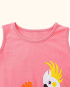 Blush pink kids sleeveless dress with round neckline and tropical parrot print, neckline close-up