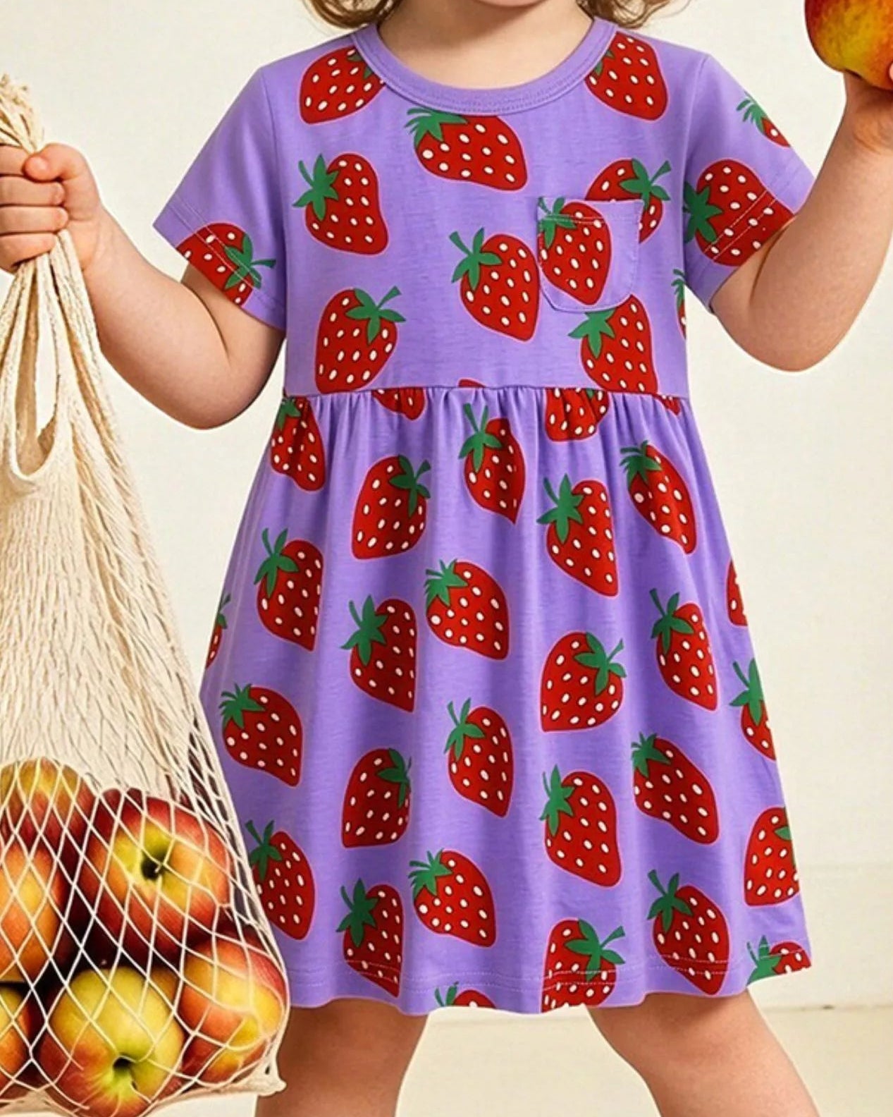 Purple kids strawberry print dress worn by child, front lifestyle view