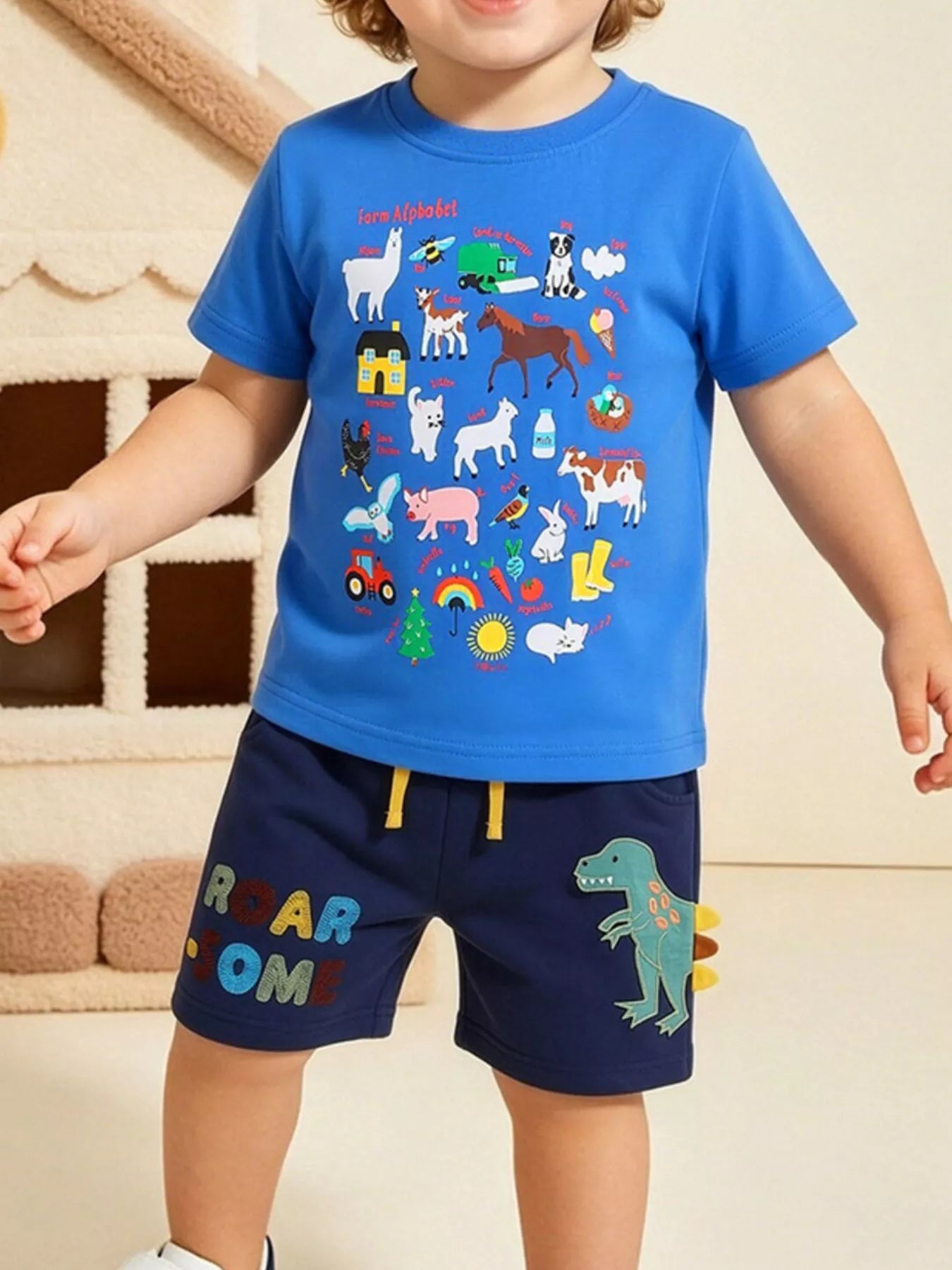 Blue kids farm alphabet T-shirt and navy dinosaur shorts set, modeled front view