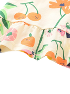 Beige kids floral and fruit print T-shirt with gathered ruffle hem, close-up detail view