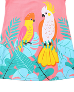 Blush pink kids dress with colorful parrots and tropical leaf print, front design close-up