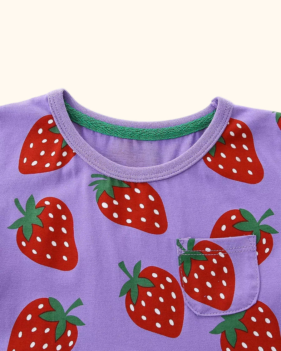 Purple kids strawberry print dress with round neckline and chest pocket, upper front close-up